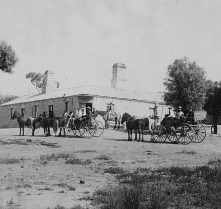 Horse-drawn coaches and buggies gathered in front of the hotel