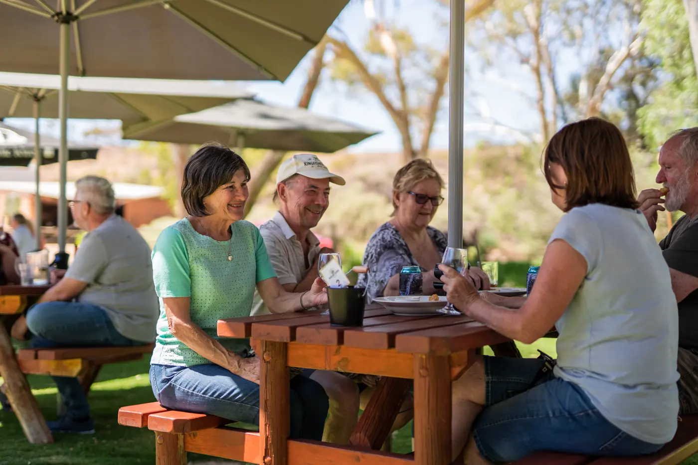 Friends around a picnic table on the lawn